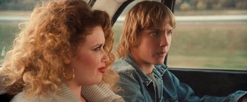 Movie still from “Detroit Rock City” (1999), directed by Adam Rifkin – A man and a woman sitting in a car looking out the window; Close Up shot, Over the shoulder angle
