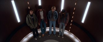 Movie still from “Detroit Rock City” (1999), directed by Adam Rifkin – A group of young men standing next to each other; Wide shot, Overhead angle