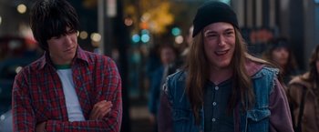 Movie still from “Detroit Rock City” (1999), directed by Adam Rifkin – Two young men standing next to each other on the street; Medium shot, Over the shoulder angle