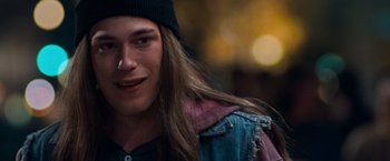 Movie still from “Detroit Rock City” (1999), directed by Adam Rifkin – A man with long hair wearing a beanie; Close Up shot, Over the shoulder angle