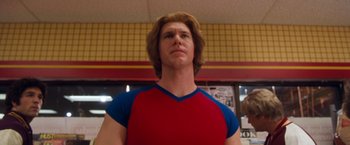 Movie still from “Detroit Rock City” (1999), directed by Adam Rifkin – A man in a red shirt and blue shirt looking to his left; Close Up shot, Low angle