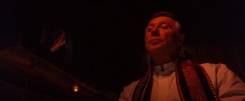 Movie still from “Detroit Rock City” (1999), directed by Adam Rifkin – An older man wearing a white shirt and a red scarf; Close Up shot, Low angle