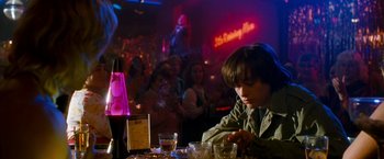 Movie still from “Detroit Rock City” (1999), directed by Adam Rifkin – A young boy sitting at a table in front of a group of people; Medium shot, High angle