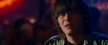 Movie still from “Detroit Rock City” (1999), directed by Adam Rifkin – A person with long brown hair; Close Up shot, Over the shoulder angle