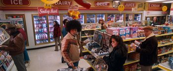 Movie still from “Detroit Rock City” (1999), directed by Adam Rifkin – A man and a woman shopping in a grocery store; Medium shot, Over the shoulder angle