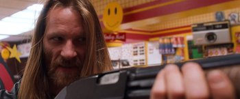 Movie still from “Detroit Rock City” (1999), directed by Adam Rifkin – A person with long hair holding a video game controller; Close Up shot, Low angle