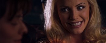 Movie still from “Detroit Rock City” (1999), directed by Adam Rifkin – A woman's face in a dark room; Close Up shot, Over the shoulder angle