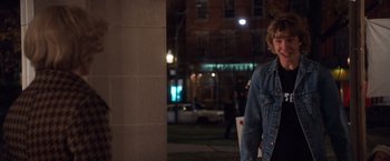 Movie still from “Detroit Rock City” (1999), directed by Adam Rifkin – A person standing in front of a building at night; Medium shot, Over the shoulder angle