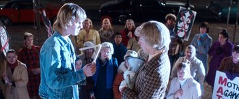 Movie still from “Detroit Rock City” (1999), directed by Adam Rifkin – A group of people standing in front of each other; Medium shot, Over the shoulder angle