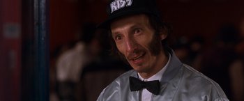 Movie still from “Detroit Rock City” (1999), directed by Adam Rifkin – A person wearing a hat and a bow tie; Close Up shot, Over the shoulder angle