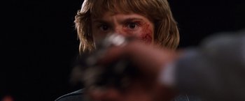 Movie still from “Detroit Rock City” (1999), directed by Adam Rifkin – A person holding a gun; Close Up shot, Low angle
