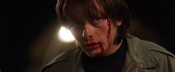 Movie still from “Detroit Rock City” (1999), directed by Adam Rifkin – A young man with blood on his face; Close Up shot, Low angle