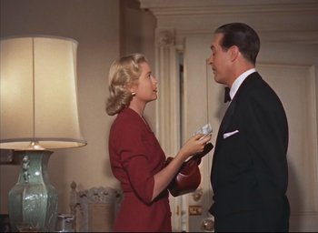 Movie still from “Dial M for Murder” (1954), directed by Alfred Hitchcock – A man and a woman in a room with a lamp; Medium shot, Low angle