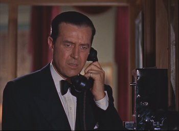 Movie still from “Dial M for Murder” (1954), directed by Alfred Hitchcock – A person talking on a phone; Close Up shot, Low angle