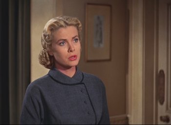 Movie still from “Dial M for Murder” (1954), directed by Alfred Hitchcock – A woman with blonde hair wearing a blue dress; Close Up shot, Over the shoulder angle