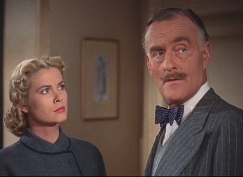 Movie still from “Dial M for Murder” (1954), directed by Alfred Hitchcock – A man and a woman standing next to each other in a room; Close Up shot, Low angle