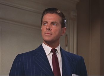 Movie still from “Dial M for Murder” (1954), directed by Alfred Hitchcock – A man in a suit and a tie; Close Up shot, Low angle