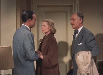 Movie still from “Dial M for Murder” (1954), directed by Alfred Hitchcock – Two men and a woman in a room; Medium shot, Over the shoulder angle