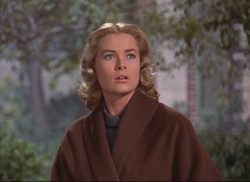 Movie still from “Dial M for Murder” (1954), directed by Alfred Hitchcock – A woman with blonde hair wearing a brown robe; Close Up shot, Low angle