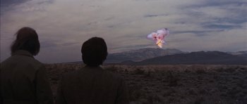 Movie still from “Diamonds Are Forever” (1971), directed by Guy Hamilton – A man in a field looking at a cloud; Extreme Wide shot, Over the shoulder angle
