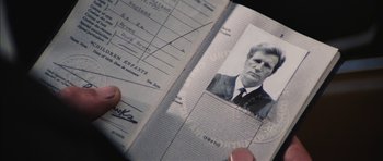Movie still from “Diamonds Are Forever” (1971), directed by Guy Hamilton – A person is holding a passport with a picture of a man; Extreme Close Up shot, Overhead angle