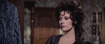 Movie still from “Diamonds Are Forever” (1971), directed by Guy Hamilton – A person wearing a black dress; Close Up shot, Over the shoulder angle