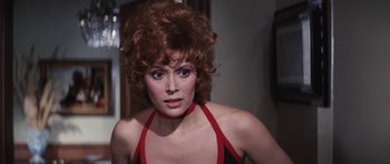Movie still from “Diamonds Are Forever” (1971), directed by Guy Hamilton – A person wearing a red and black top; Close Up shot, Over the shoulder angle