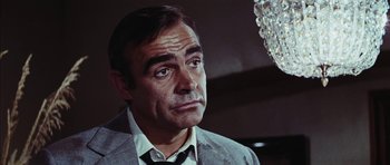 Movie still from “Diamonds Are Forever” (1971), directed by Guy Hamilton – Sean connery wearing a suit and tie; Close Up shot, Low angle