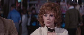 Movie still from “Diamonds Are Forever” (1971), directed by Guy Hamilton – A person wearing a white jacket; Close Up shot, Over the shoulder angle