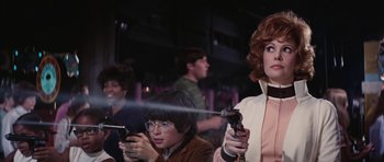 Movie still from “Diamonds Are Forever” (1971), directed by Guy Hamilton – A group of people playing a video game together; Medium shot, Low angle