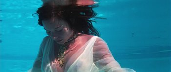 Movie still from “Diamonds Are Forever” (1971), directed by Guy Hamilton – A woman in a white dress is under the water; Close Up shot, High angle