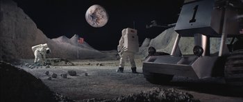 Movie still from “Diamonds Are Forever” (1971), directed by Guy Hamilton – An image of an astronaut on the moon next to a car; Extreme Wide shot, High angle