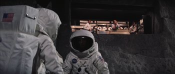 Movie still from “Diamonds Are Forever” (1971), directed by Guy Hamilton – Two men in spacesuits are standing next to each other; Wide shot, Low angle