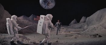 Movie still from “Diamonds Are Forever” (1971), directed by Guy Hamilton – A man in a spaceman suit walking on the moon; Wide shot, High angle