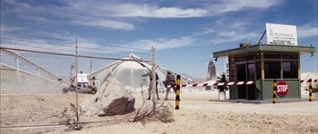 Movie still from “Diamonds Are Forever” (1971), directed by Guy Hamilton – A fence that has been cut off from the beach; Extreme Wide shot, Low angle