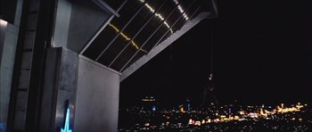 Movie still from “Diamonds Are Forever” (1971), directed by Guy Hamilton – A man hanging from a rope over a city at night; Extreme Wide shot, Overhead angle