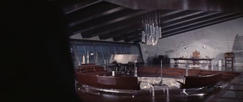 Movie still from “Diamonds Are Forever” (1971), directed by Guy Hamilton – A room filled with lots of tables and chairs; Extreme Wide shot, Low angle