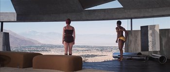 Movie still from “Diamonds Are Forever” (1971), directed by Guy Hamilton – Two women in bathing suits standing on a platform; Extreme Wide shot, Low angle