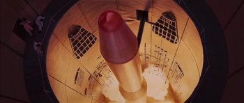 Movie still from “Diamonds Are Forever” (1971), directed by Guy Hamilton – A red lipstick sitting on top of a lipstick tube; Extreme Close Up shot, Overhead angle