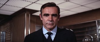 Movie still from “Diamonds Are Forever” (1971), directed by Guy Hamilton – A person wearing a suit and tie; Close Up shot, Low angle