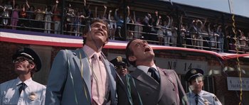 Movie still from “Diamonds Are Forever” (1971), directed by Guy Hamilton – Two men in suits and ties looking up into the sky; Medium shot, Low angle
