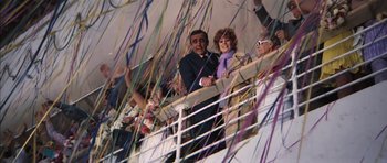 Movie still from “Diamonds Are Forever” (1971), directed by Guy Hamilton – A group of people standing on top of a railing next to a railing; Wide shot, High angle