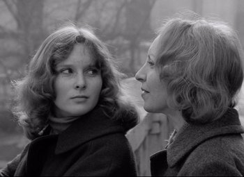 Two women looking at each other in a black and white photo