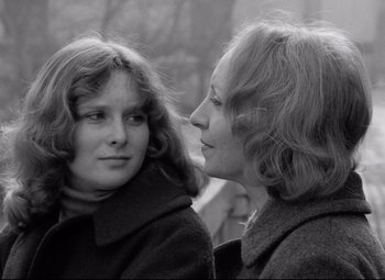 A woman and a young girl looking into each others eyes