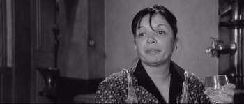 Movie still from “Diary of a Chambermaid” (1964), directed by Luis Buñuel – An older woman is looking at the camera; Close Up shot, Over the shoulder angle