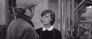 Movie still from “Diary of a Chambermaid” (1964), directed by Luis Buñuel – An old photo of a man and a woman; Medium shot, Over the shoulder angle