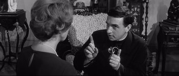 Movie still from “Diary of a Chambermaid” (1964), directed by Luis Buñuel – A black and white photo of a man and a woman; Close Up shot, Over the shoulder angle