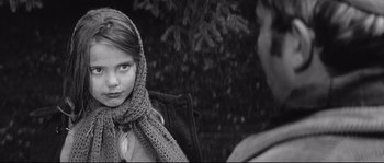 Movie still from “Diary of a Chambermaid” (1964), directed by Luis Buñuel – A young girl wearing a scarf looking at a man; Close Up shot, Over the shoulder angle