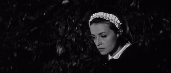 Movie still from “Diary of a Chambermaid” (1964), directed by Luis Buñuel – A black and white photo of a woman wearing a maid's hat; Close Up shot, High angle