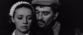 Movie still from “Diary of a Chambermaid” (1964), directed by Luis Buñuel – An old photo of a man and a woman; Close Up shot, High angle